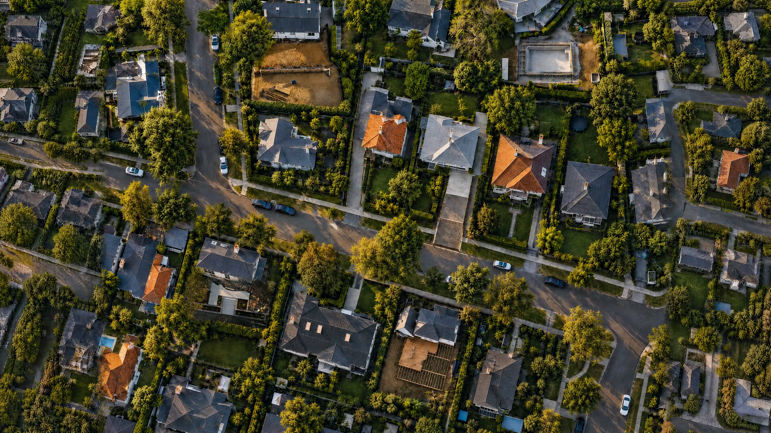 Aerial view of an Auckland suburb with several outdoor-construction jobs under way